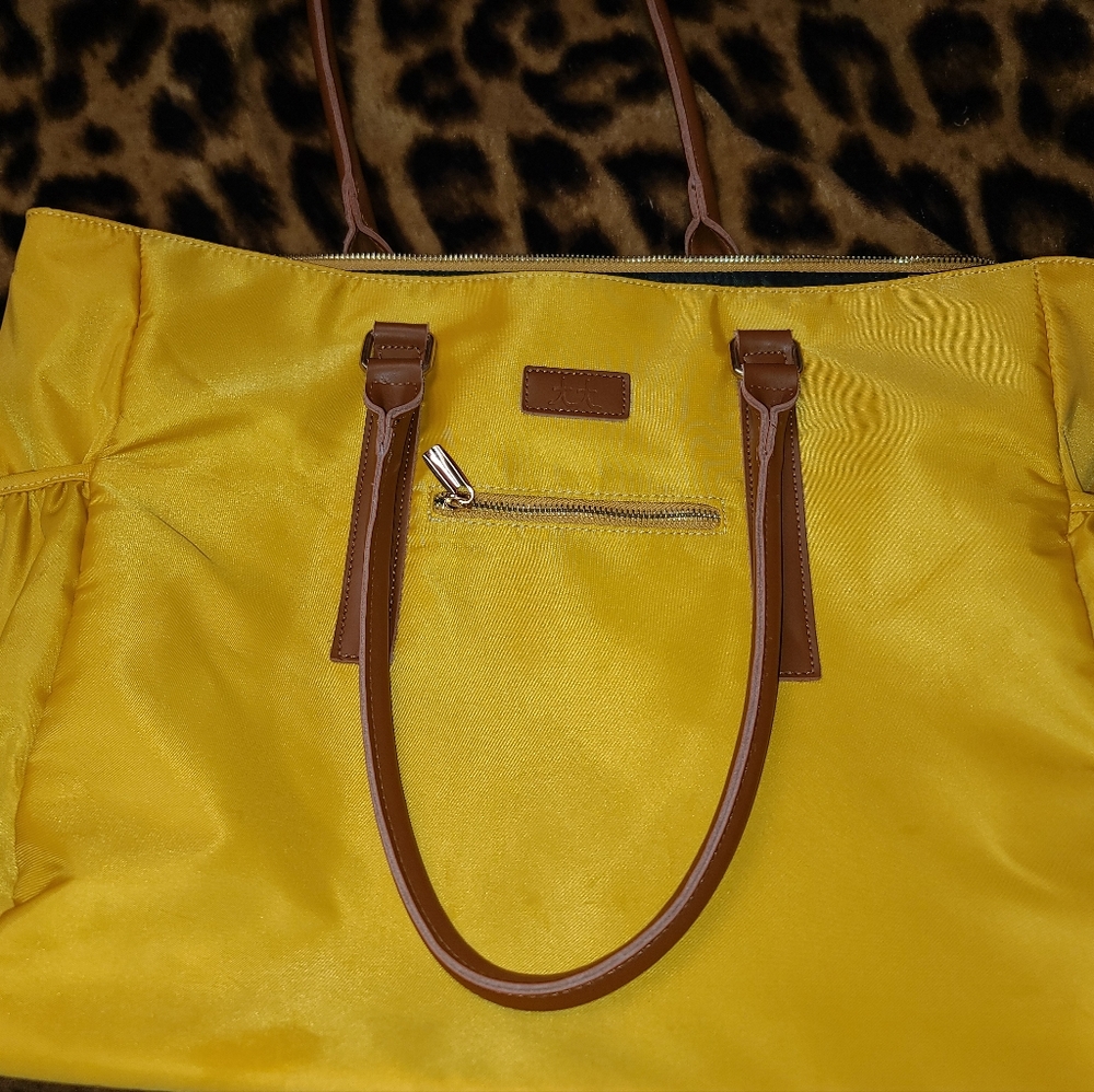 Mustard yellow in color. Brand - Teacher Tote.
